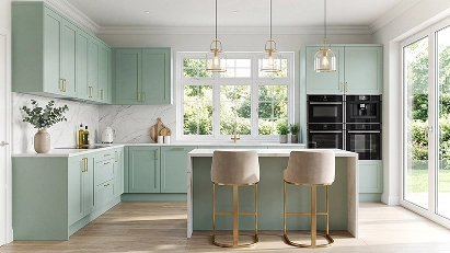Matt modern kitchen cabinets in soft green with an island and bright open-plan layout.