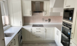 A Fenwick Shaker kitchen in Dublin with ivory doors, quartz worktops and Boston bar handles.