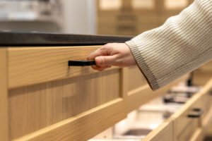 hand opens modern kitchen drawer minimal storage