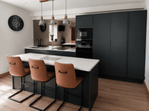 Finished handleless slab kitchen in Dublin with island, tall storage and open-plan layout.