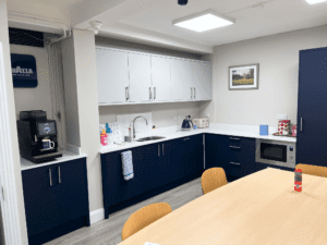 Marine blue and white office kitchen with staff break area in Dublin