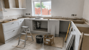 Light grey shaker kitchen installation in Dublin with cabinets fitted before quartz worktop templating.