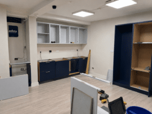 Installation process for a marine blue and white office kitchen in Dublin