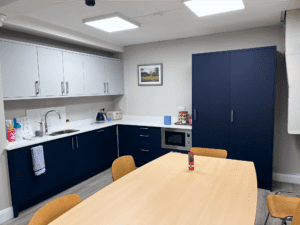 Marine blue and white office kitchen with slab doors in Dublin