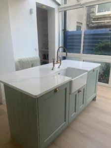 Sage green shaker kitchen island with ceramic undermount sink in Dublin