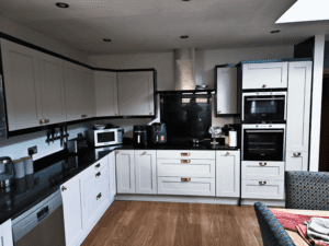 White shaker fitted kitchen cabinets with black worktops in a Dublin home