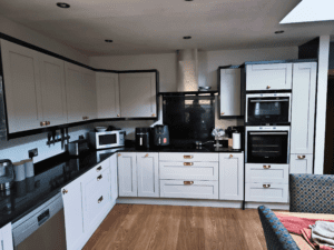 White shaker fitted kitchen with black worktops in Dublin