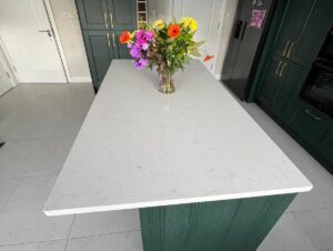 White quartz kitchen island with forest green Shaker cabinetry in Killiney Dublin
