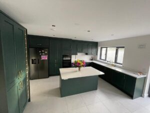 Wide view of forest green Shaker fitted kitchen with island in Killiney Dublin