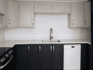 Close-up of an indigo and grey Shaker kitchen in Lucan, Dublin featuring a sink, dishwasher, white worktop and two-tone cabinets