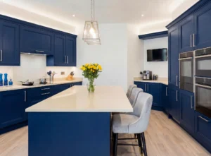 Blue fitted kitchen in an Irish home with island seating, ideal for a kitchen renovation finance guide