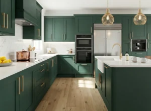 Heritage green Shaker kitchen with brass handles, white worktops, integrated appliances and island sink