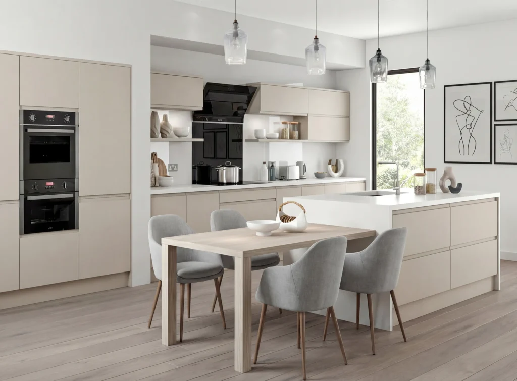 Modern cashmere kitchen renovation with island, dining table, integrated ovens and pendant lighting in a bright Irish home