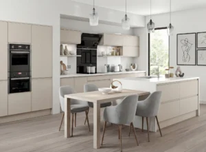 Open-plan kitchen layout in Dublin home with central island, dining area, cashmere cabinets, built-in ovens and large window