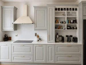 Sage green Shaker kitchen with hob, open shelving and wine storage in Clontarf, Dublin