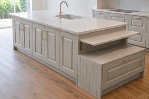 Sage green Shaker kitchen island with undermount sink and pull-out table in Clontarf, Dublin
