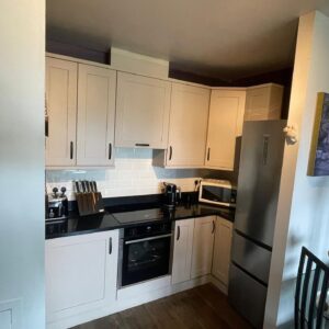Compact Light Grey U-shaped fitted kitchen with integrated appliances in Raheny, Dublin