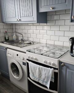 Denim Shaker sink and cooker run with white worktop in Raheny, Dublin