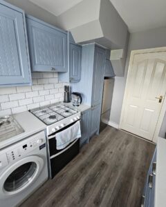 Tall Denim Shaker storage beside the fridge in a Raheny galley kitchen