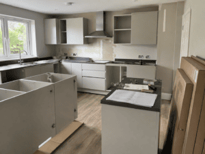 DIY kitchen installation with flat pack cabinets being assembled in an Irish home