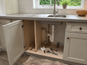 Kitchen plumbing changes under the sink during installation in an Irish home