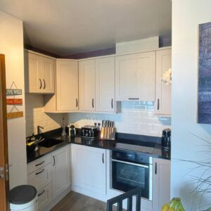 Light Grey U-shaped Shaker kitchen with Black Andromeda worktops in Raheny, Dublin