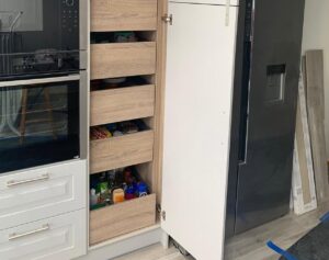 Pantry pull-out storage beside integrated oven in a Glasnevin Dublin kitchen