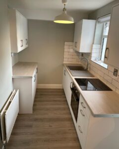 White Grey galley kitchen with two-sided storage in Santry, Dublin