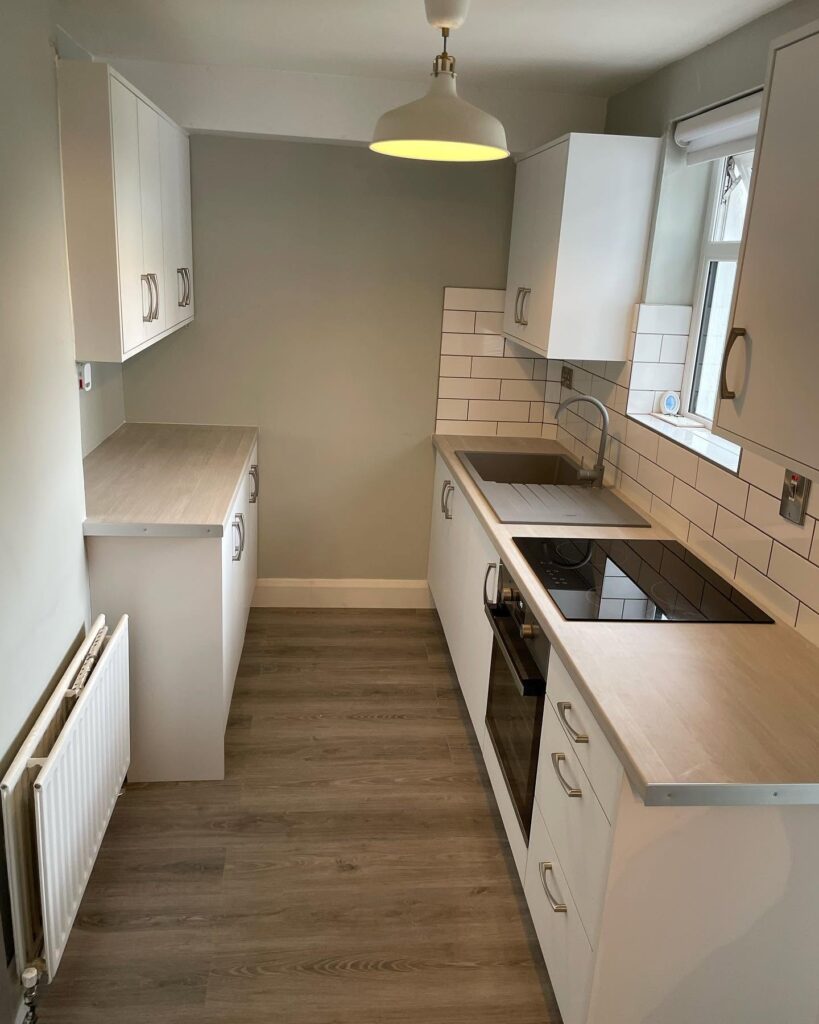 White Grey galley kitchen with two-sided storage in Santry, Dublin