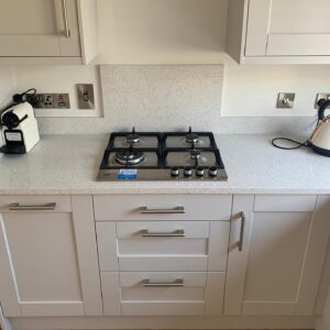 Gas hob and pan drawers in a white grey Shaker kitchen in Raheny, Dublin