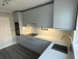White handleless kitchen with sink and hob layout in Malahide, Dublin