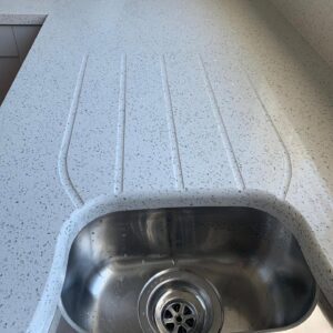 White quartz worktop with drainer grooves in a Raheny Dublin kitchen