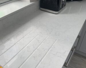 White quartz worktop with drainer grooves in a Glasnevin Dublin kitchen