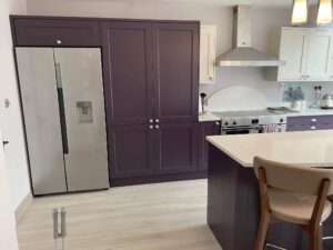 The fridge now sits between full-height storage units, rather than standing alone against the wall. Materials & Finishes