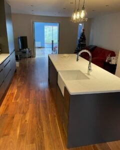 Graphite handleless kitchen island with a Belfast sink and white quartz worktop in Rathfarnham, Dublin