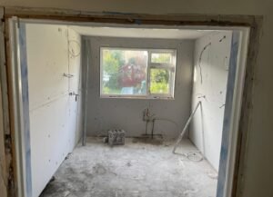 Kitchen stripped back to bare walls and subfloor during a full renovation in Swords, Dublin