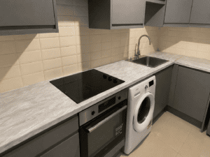 Close-up of a light grey marble-effect worktop with Dust Grey handleless cabinets in a Clontarf kitchen