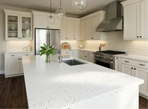 White Andromeda worktop on a large island with an integrated sink in a white Shaker kitchen in an Irish home.