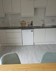 White Grey handleless kitchen with a stainless steel sink, dishwasher and dark worktop in Lucan, Dublin