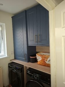 Marine Blue Berwick shaker cabinetry above a washing machine and dryer in a Swords utility room