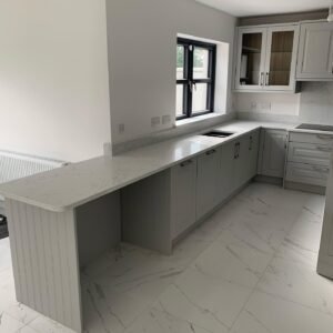 Breakfast bar extending from the window-side worktop in a Castleknock kitchen
