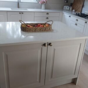 Central island in a Porcelain Shaker kitchen in Clontarf, Dublin, showing bronze knobs and worktop detail