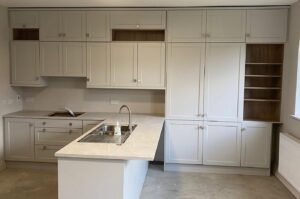 White Shaker kitchen with a sink peninsula in Portmarnock, Dublin