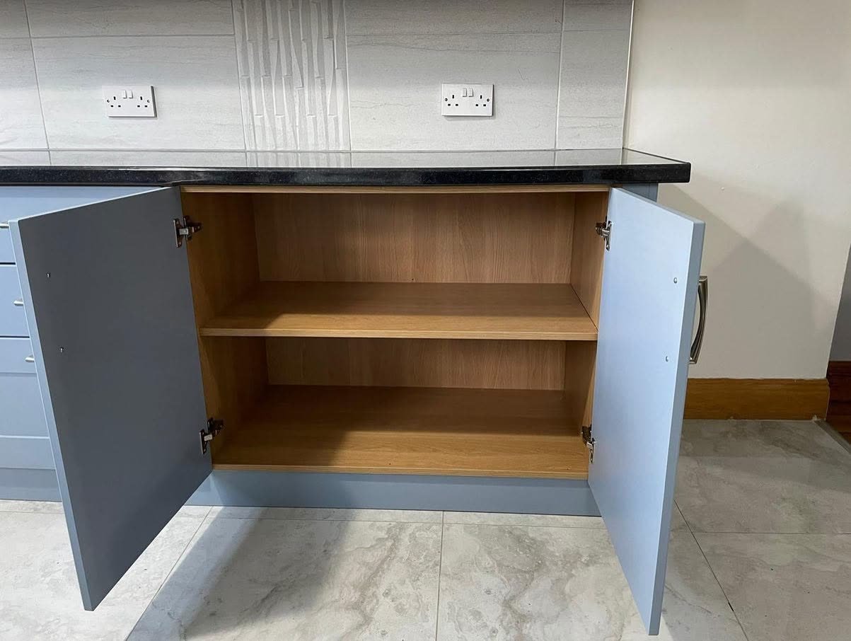 Open double base cupboard with new Denim doors on the original oak-effect cabinet with a single shelf