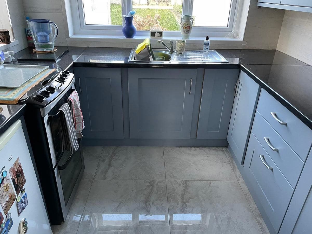 Compact U-shaped kitchen in Clondalkin with Denim blue-grey shaker doors, silver handles and a dark speckled worktop